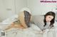 A woman laying on top of a bed in a bedroom.