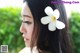 A woman with a white flower in her hair.