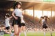 A group of young women playing soccer on a field.